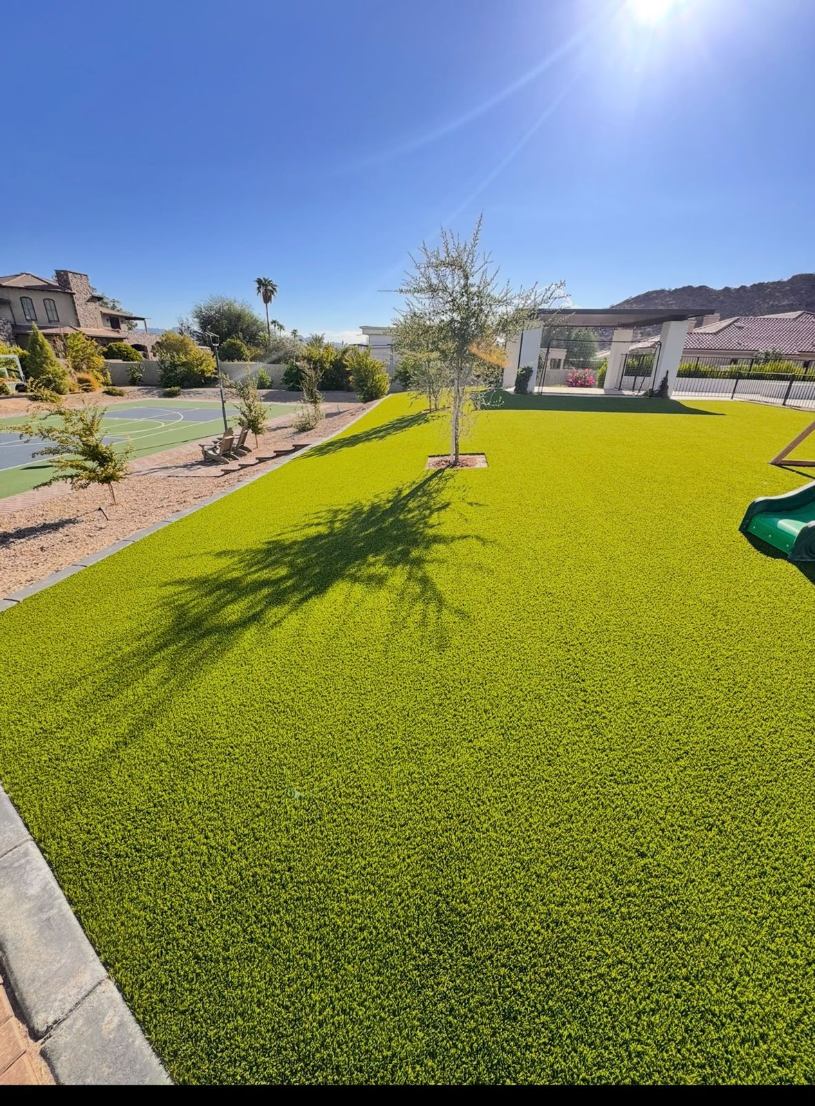 Backyard with artificial turf and decorative rock built by AZ Wide Landscaping in Phoenix, AZ